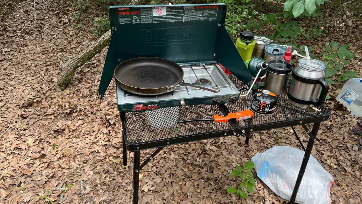 Camping stove on a table with propane cannister 