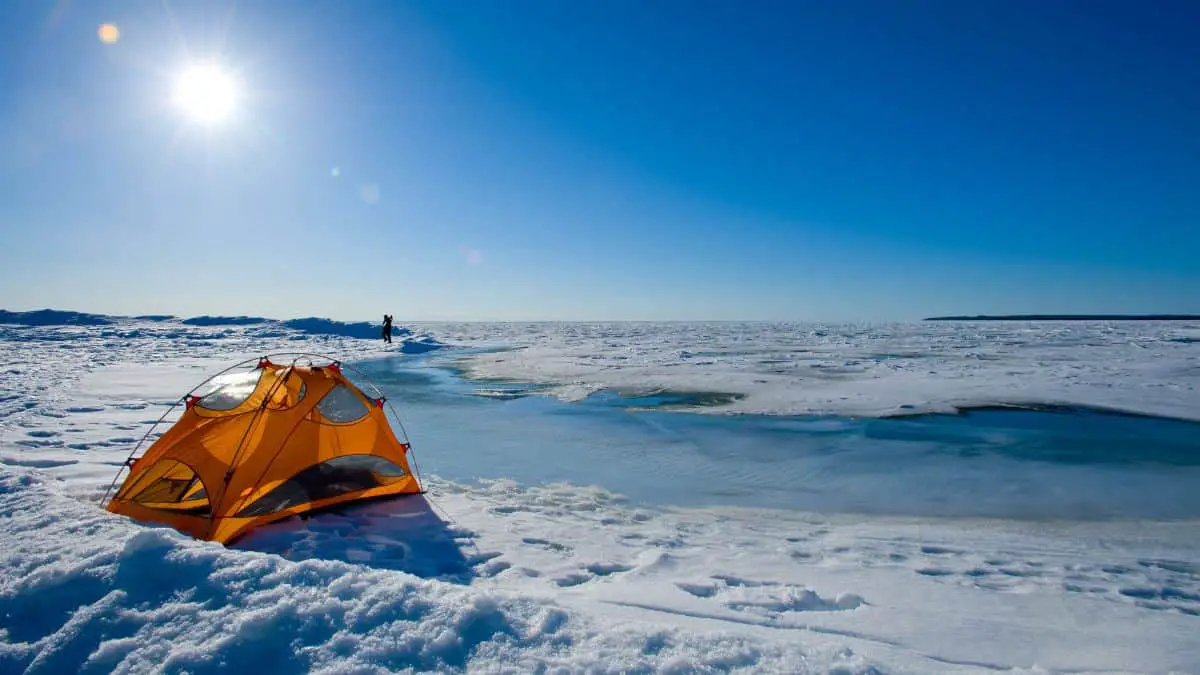 a tent with a camping heater in the snow