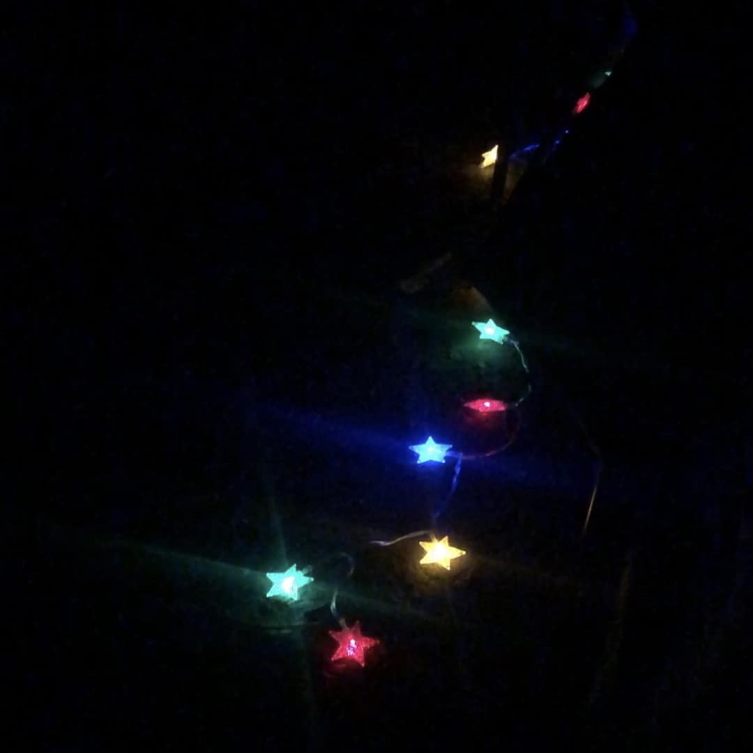 Decorative blinking LED lights shaped like stars in different colors provide decoration around the campsite