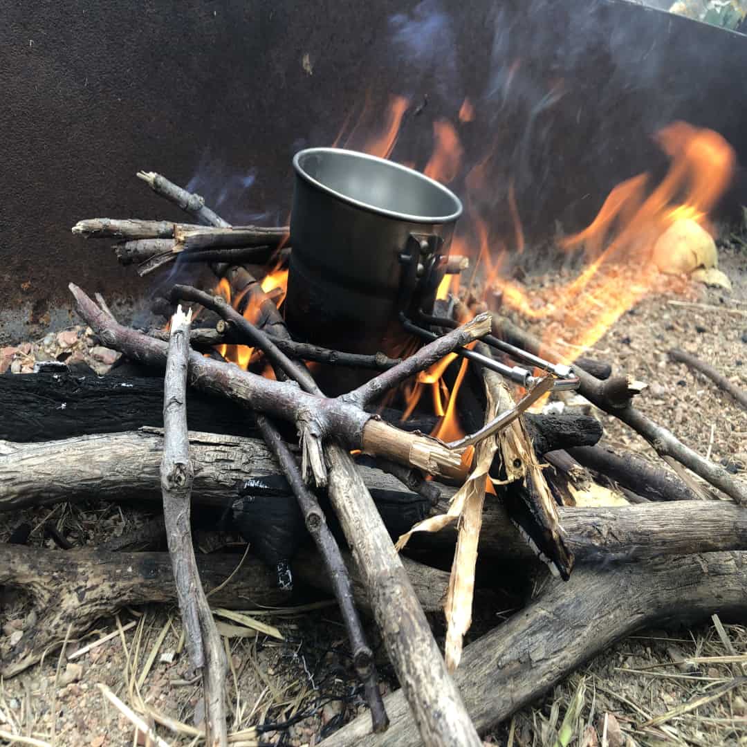 A photo of heating water over a campfire