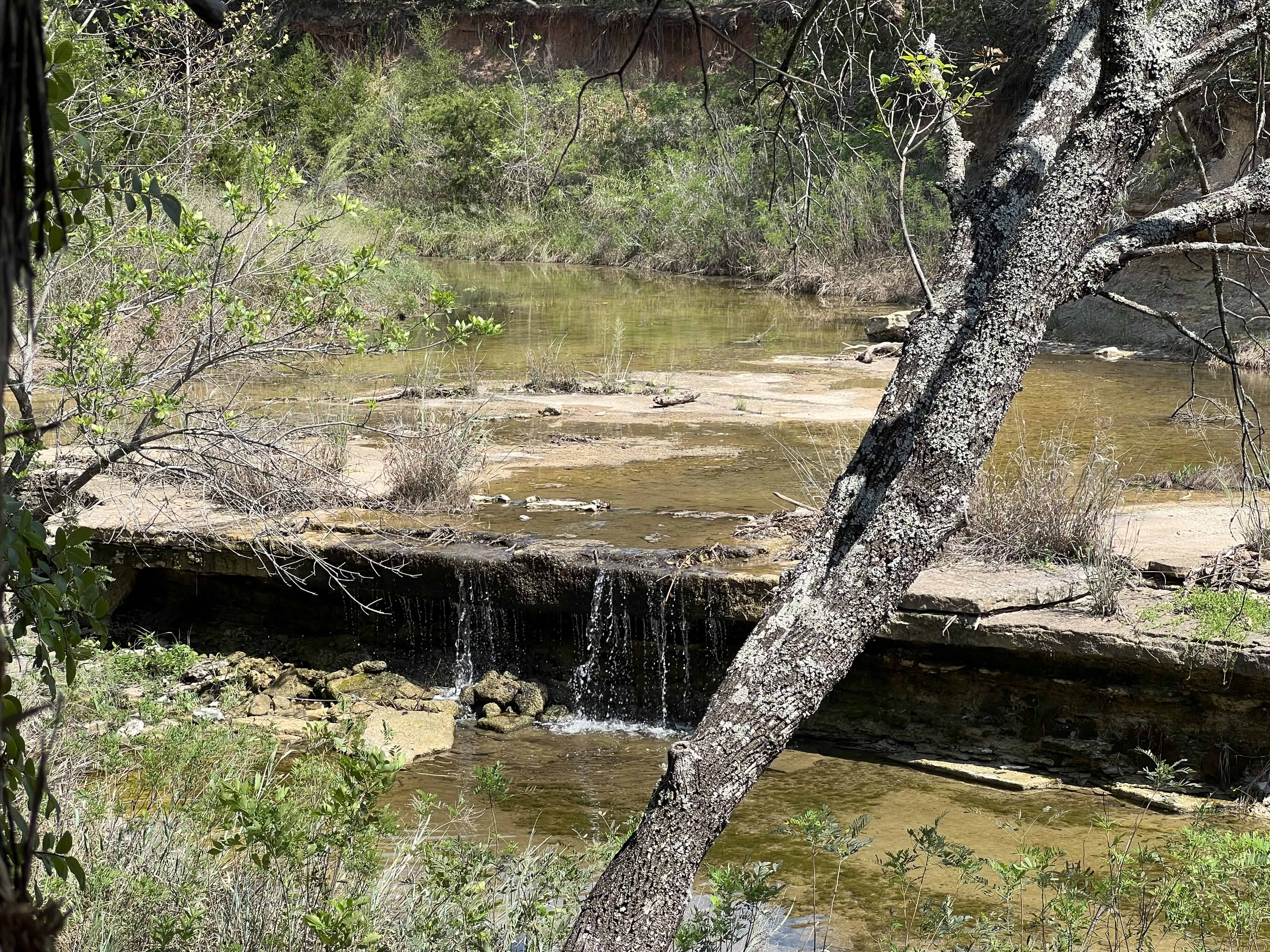 Small waterfall at Deer Creek campground HipCamp Texas