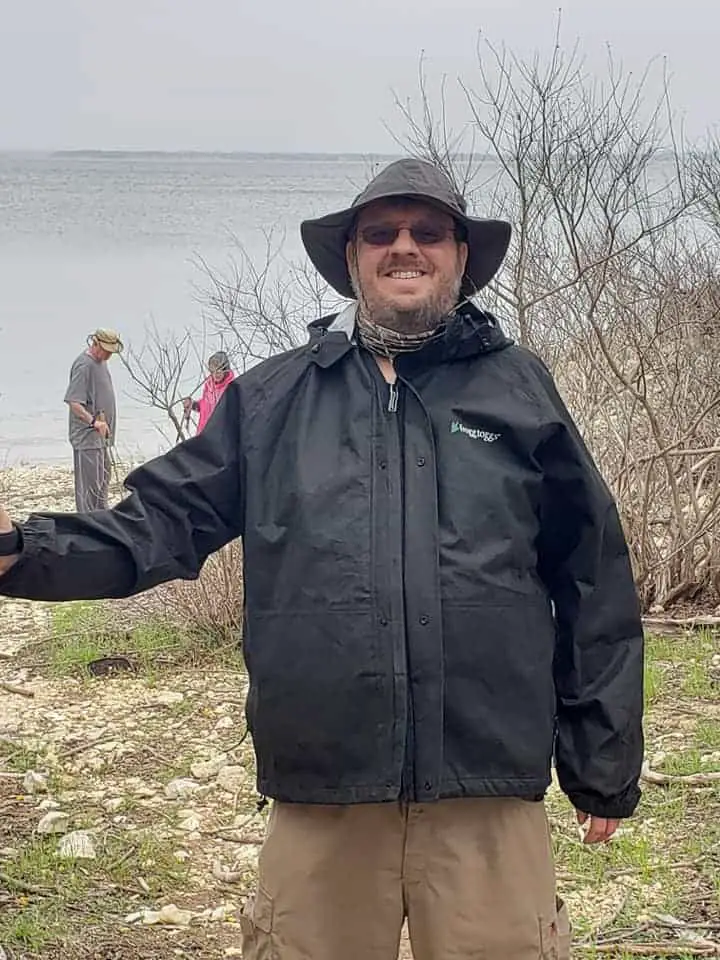 Mark Wilcox wearing his rain suit camping in the rain.