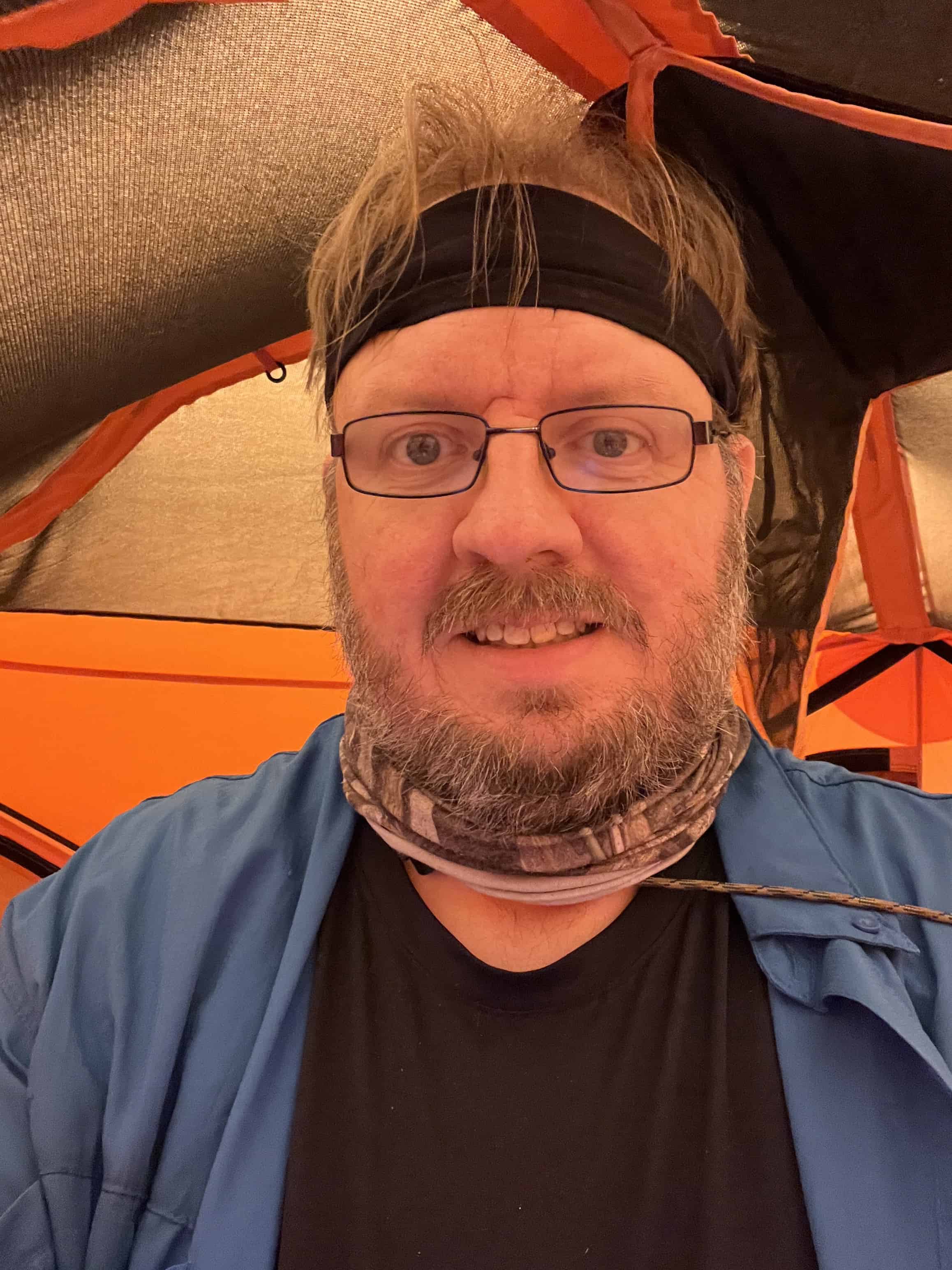 Mark standaing up in a Gazelle T4 tent at a campground