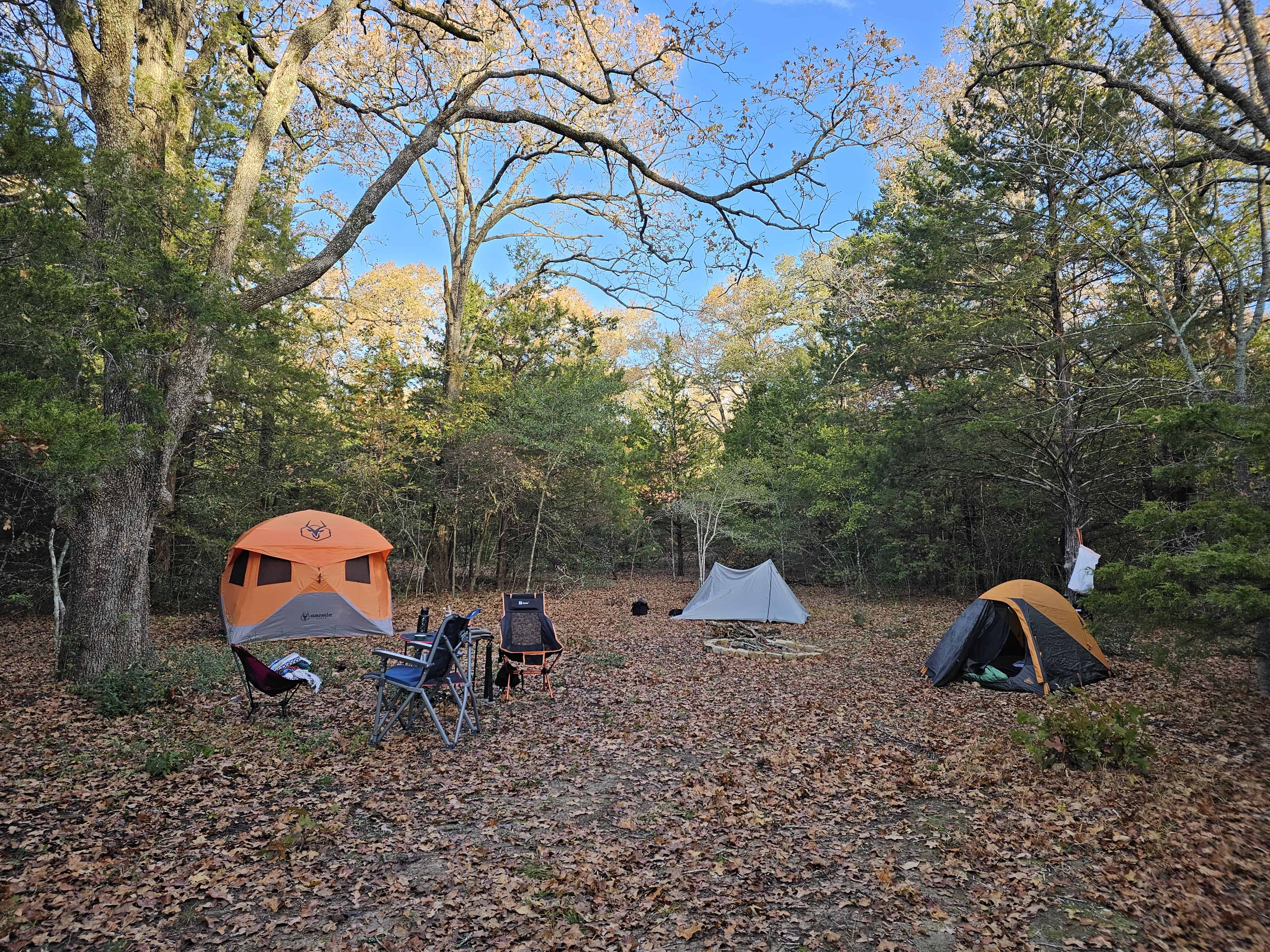 photograph of a collection of tents at a primitive campsite