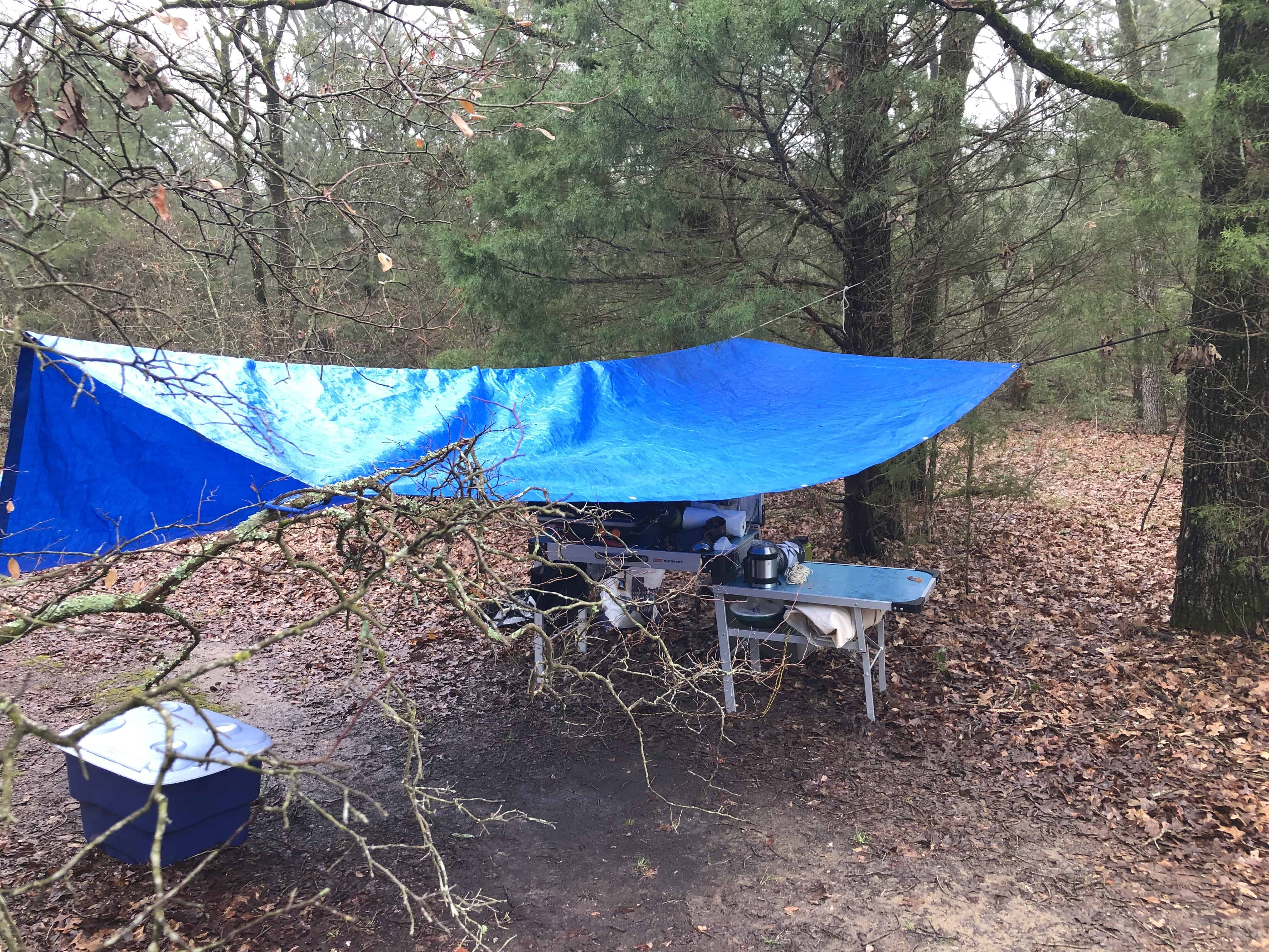 Photograph of a tarp over a camping kitchen