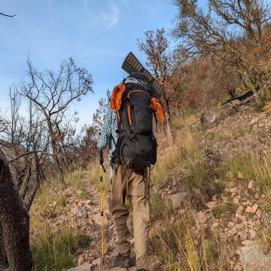 Mark Wilcox of Camping Forge backpacking up a mountaing in Big Bend National Park